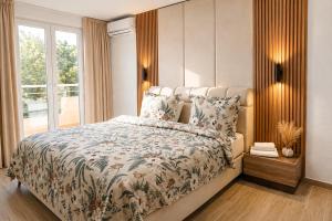 a bedroom with a large bed with a large window at Villa Alera in Dobra Voda +11 photos