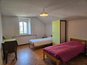 a bedroom with two beds and a green cabinet at Gîte VINCENT in Château-Salins