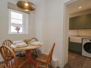 a kitchen and dining room with a table and chairs at Middle Cottage in Salisbury +13 photos