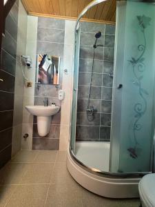 a bathroom with a shower and a sink at Yüce Suite in Uzungöl +23 photos