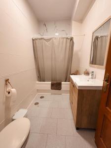 a bathroom with a toilet and a sink and a shower at Casa Almonte in Almonte +13 photos
