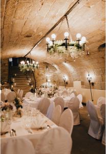 a banquet hall with white tables and chairs at Hotel Kallstadter Hof in Kallstadt