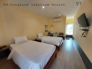 a hotel room with two beds and a tv at Dungkaew lakeview resort in Amphoe Ban Dung +12 photos
