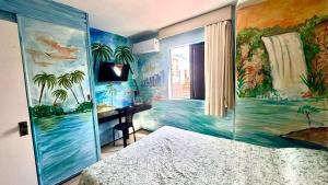 a bedroom with a bed and a painting on the wall at Praia Mansa Suite Hotel Flat in Fortaleza +12 photos