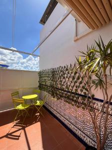 a balcony with a table and chairs and a plant at Casa Almonte in Almonte