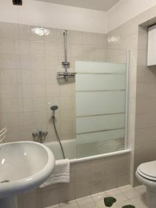 a bathroom with a tub and a sink and a toilet at Il re di Torino in Turin +5 photos