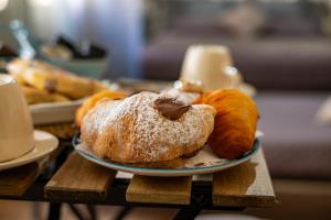 two pastries on a plate on a table at B&B Son De Mar in Salerno