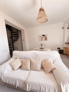 a bedroom with a white bed with pillows at Casa Almonte in Almonte