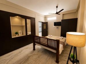 a bedroom with a bed and a lamp in it at Royal Villa Pondy in Pondicherry