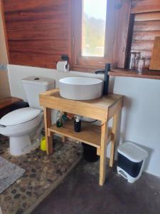 a bathroom with a sink and a toilet at Cafe Maya - Casa Acalli in Zipolite