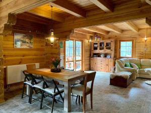 a kitchen and dining room with a table and chairs at DOM w BORACH in Cekcyn +37 photos