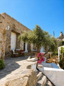 a stone house with a garden and a patio at Artemis Cottage Authentic Mykonian Stone House near Super Paradise in Super Paradise Beach