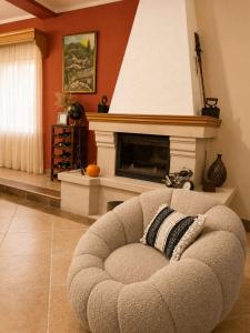 a living room with a chair and a fireplace at Villa Besha in Herceg-Novi