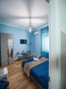 a blue bedroom with a bed and a table at B&B Son De Mar in Salerno