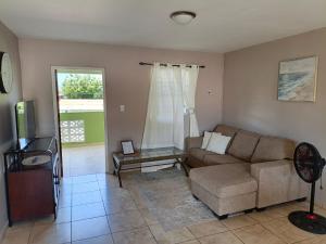 a living room with a couch and a table at Passion Care in Willemstad +1 photo