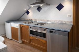 a kitchen with a sink and a stove at Ibón de tebarray in Escarrilla