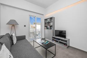 a living room with a couch and a television at Milva Apartments in Kos