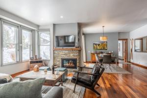 a living room with a fireplace and a table at Snowcreek V 883 in Mammoth Lakes
