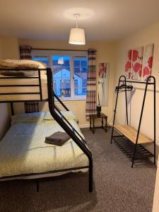 a bedroom with a bunk bed and a window at 3 Floors, Sleeps 14, 3 Baths, View, Parking, Grimsby Cleethorpes Beach in Grimsby