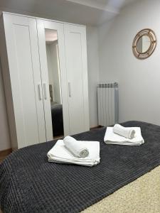 a bedroom with two white towels on a bed at APARTAHOTEL CANFRANC in Canfranc +52 photos