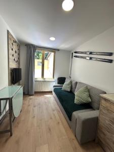 a living room with a couch and a table at APARTAHOTEL CANFRANC in Canfranc
