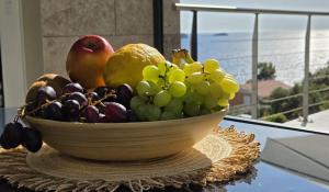 a bowl of fruit sitting on a table at Villa Vista in Blato