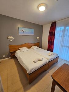 a bedroom with a bed with two towels on it at Stella Maris in Stella-Plage