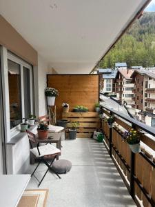 an apartment balcony with a view of a city at Layla's in Zermatt