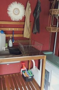 a kitchen counter with a dish drying rack and a sink at Cozy Cabin near Balka Beach with outdoor toilet and kitchen in Neksø +5 photos