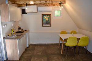a kitchen with a table and chairs and a sink at Villageescape in Cetinje