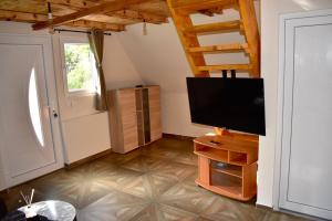 a living room with a flat screen tv and a door at Villageescape in Cetinje