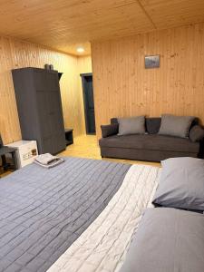 a living room with a bed and a couch at Садиба ВидНа in Kvasy