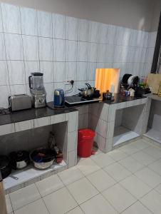 a kitchen with a counter top with many items on it at Eden Vista Stays in Dar es Salaam