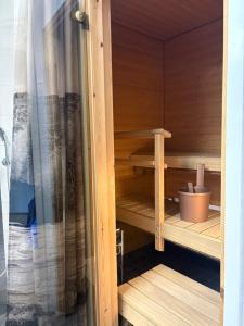 a wooden sauna with a potted plant in it at Mirella in Tampere