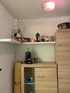 a kitchen with a counter with a microwave on a shelf at Layla's in Zermatt +7 photos