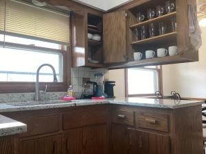a kitchen with wooden cabinets and a counter top at CBI Haven 1 & 2 in Milwaukee +80 photos