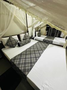 a room with two beds in a tent at Sigiriya Rock Gate Resort in Sigiriya