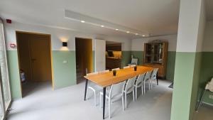 a dining room with a wooden table and chairs at Le Reflet de l'Ourthe in Durbuy +9 photos
