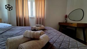 a bedroom with a bed with two towels on it at Villa Vista in Blato