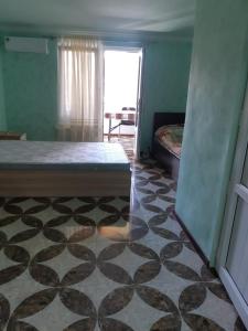 a room with a bed and a floor with a window at Адами драхт in Garni