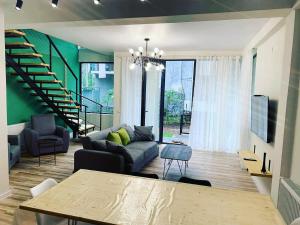 a living room with a couch and a table at Kaprovani Two Sides in Urekis Sadguri
