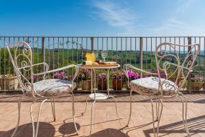 two chairs and a table on a balcony at Antica Dimora Sforza Bed & Bike in Corinaldo