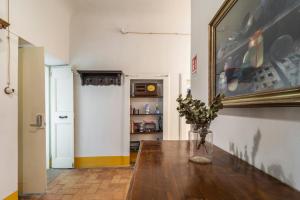 a vase of flowers on a wooden table in a room at Antica Dimora Sforza Bed & Bike in Corinaldo +52 photos