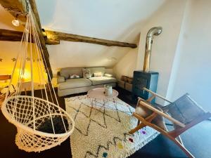a living room with a hammock and a couch at La MaisonneTTe d'ElodibiZa ! in Moret-sur-Loing