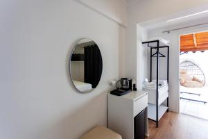 a white bathroom with a mirror and a sink at Ionio Blue in Himare +71 photos