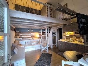 a large kitchen and living room with a loft at Plori House in Skiros
