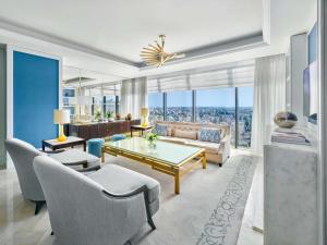 a living room with a couch and a table at Fairmont Amman in Amman