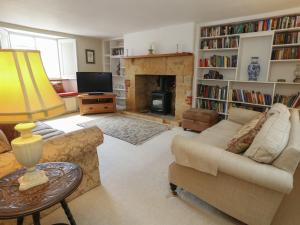a living room with a couch and a fireplace at Crantock in Sherborne