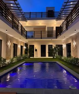 an indoor swimming pool in a house at night at Petit da Pipa Studios Privados in Pipa
