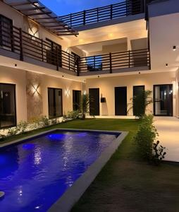 a house with a swimming pool in the yard at Petit da Pipa Studios Privados in Pipa